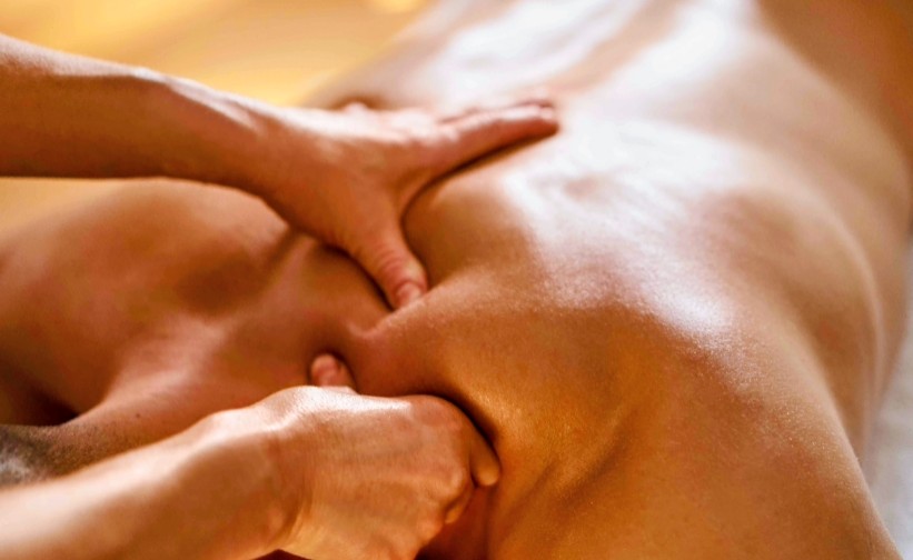 Therapist's hands working on a client's back muscles
